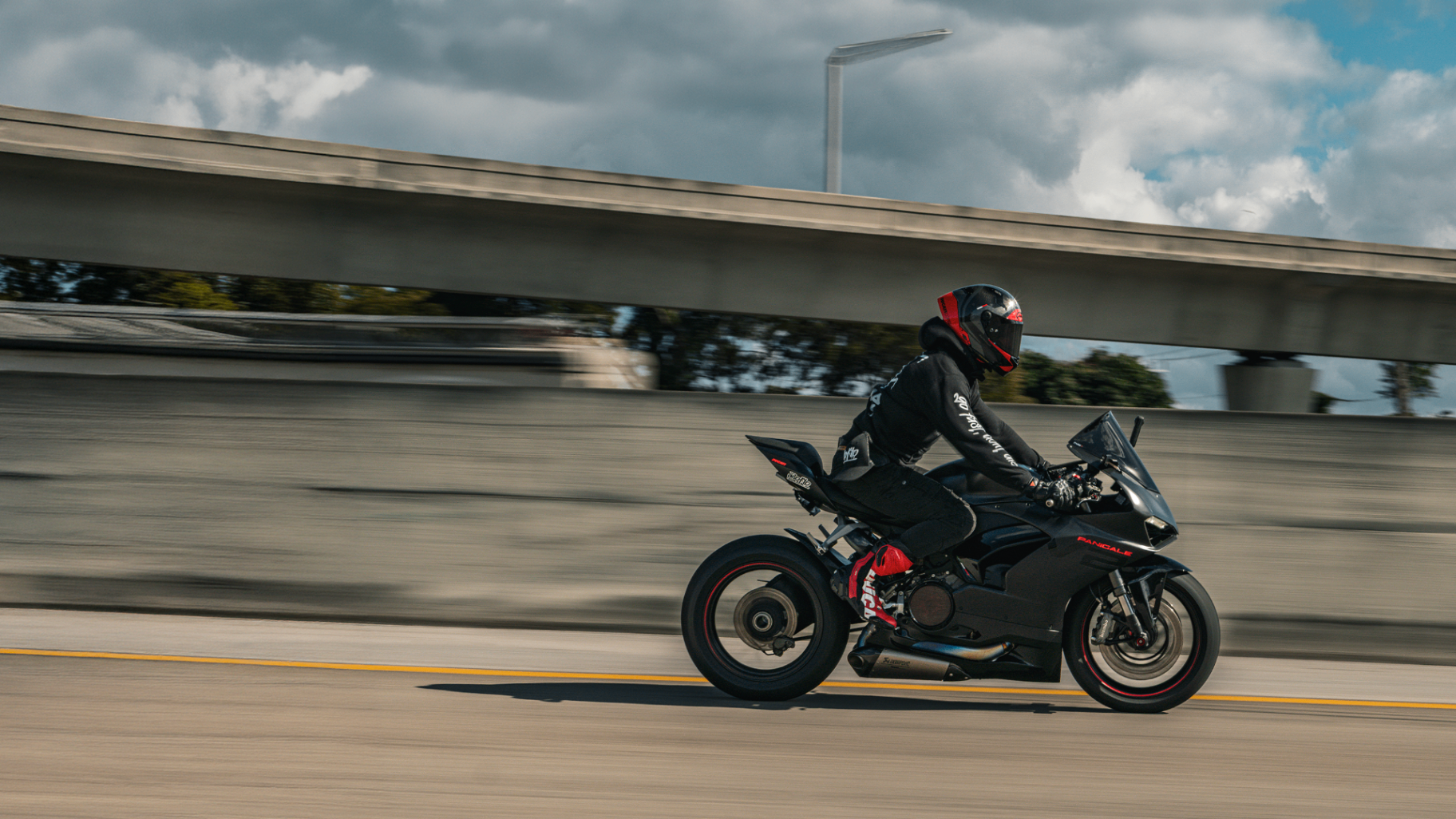 Kawasaki motorcycle rolling past fair lights at dusk — RPM Media